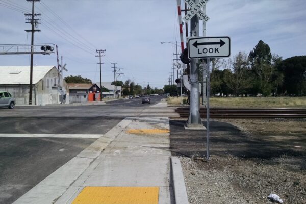 ada compliant sidewalk and look both way signs for safe railroad crossing.