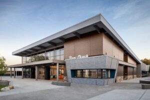 Front of the Casa Roble High School Student Union and Administration Building at dusk.